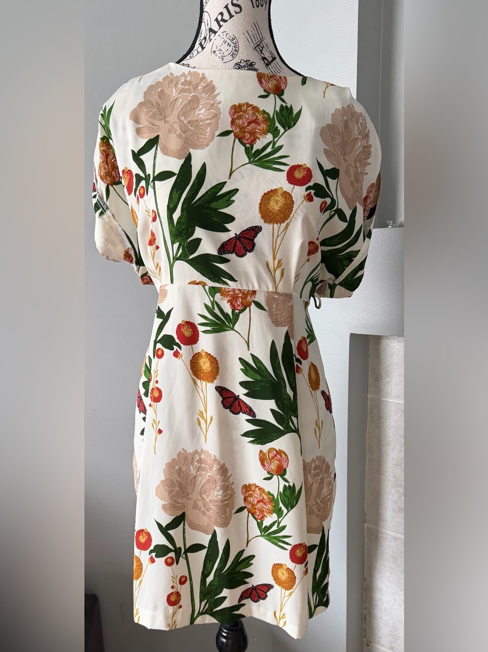 Mystic Cream Mini Dress with Green Leaves and Red-Orange Blooms